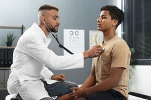 healthcare cost increase employers: boy at a doctor's appointment
